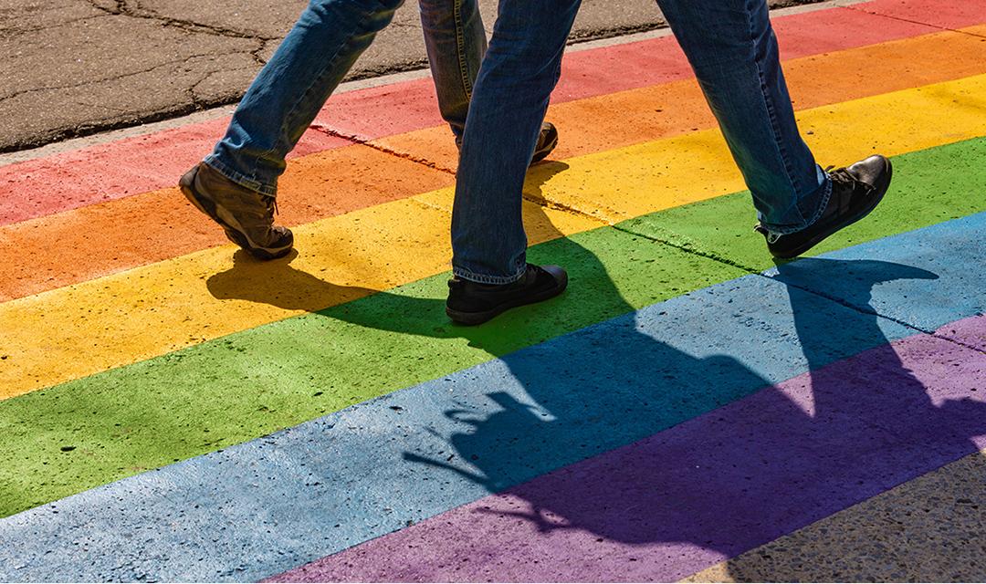 People walking on gay rainbow crosswalk in Montreal gay village