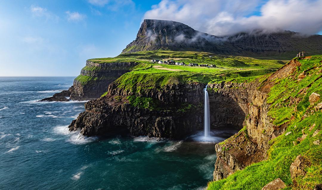 The Mulafossure waterfall on a sunny day in the Faroe Islands