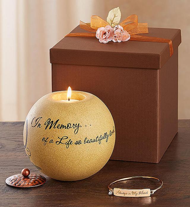 A candle holder next to a large brown gift box.