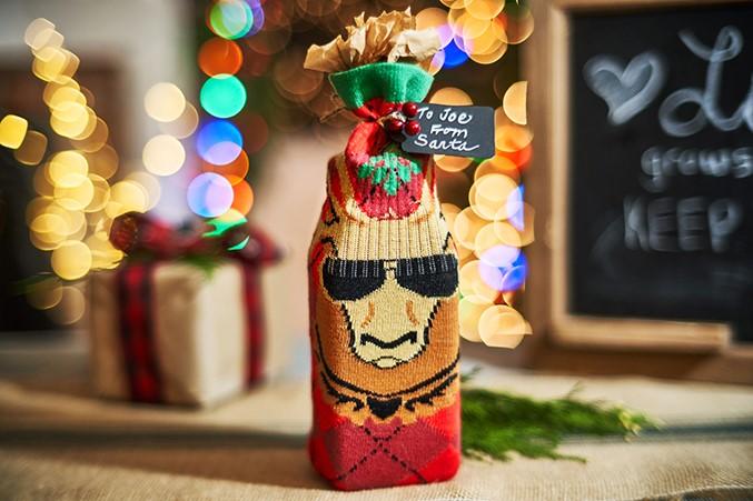 Bottle decorated with Christmas sock.