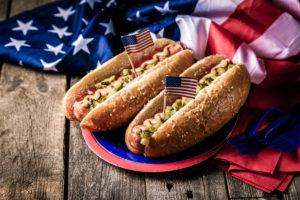 Fourth of July facts with a plate of hot dogs.
