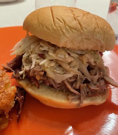 Photo of pulled pork sandwich on a plate.
