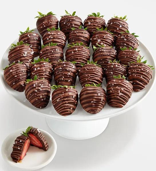 Chocolate caramel covered strawberries on a platter.