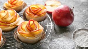 Apple image   Rack with raw rose shaped apple pastry on table