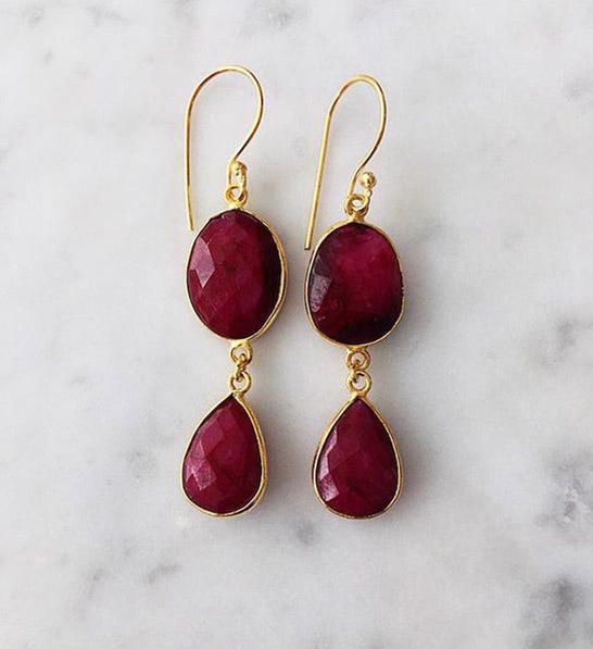anniversary gift guide image   ruby earrings with a marble background