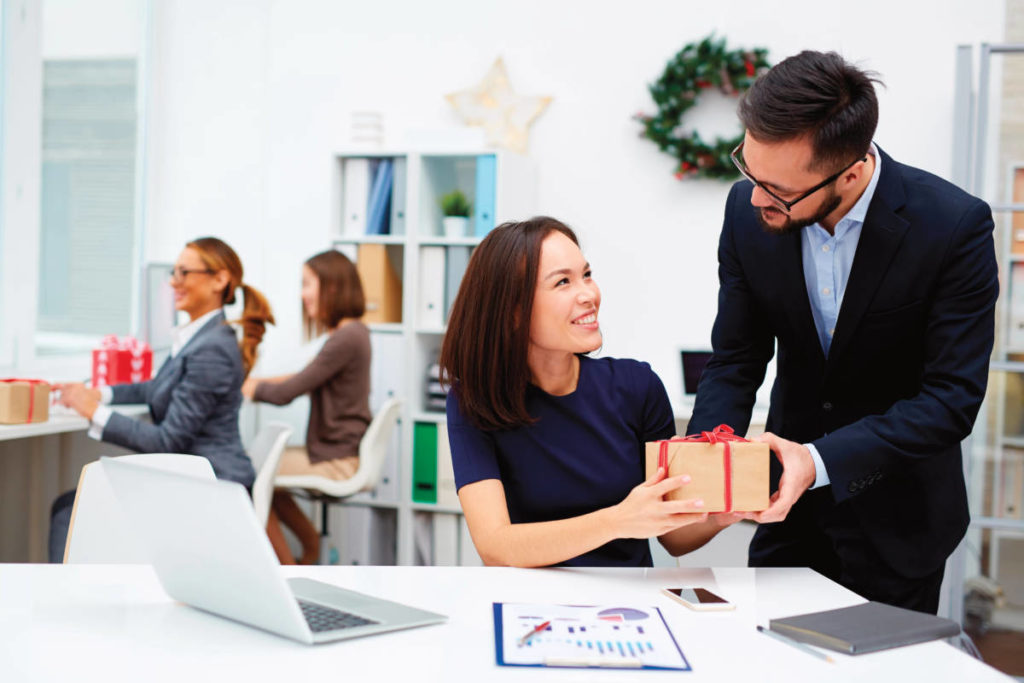 A photo of corporate gifting with coworkers exchanging gifts