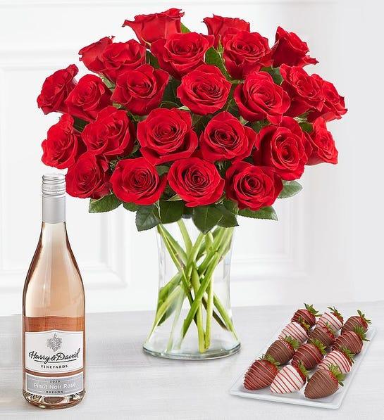 A photo of February birthday with a bouquet of roses next to a bottle of wine and a plate of chocolate covered strawberries.