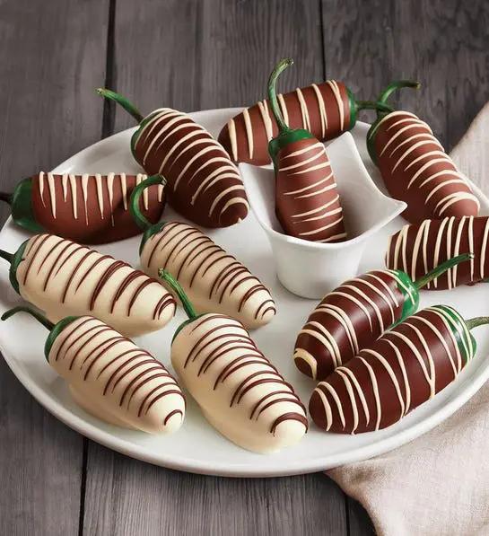 A photo of romantic foods with chocolate covered jalapenos on a platter.