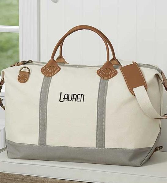 A photo of gifts for women with a personalized canvas duffel bag.