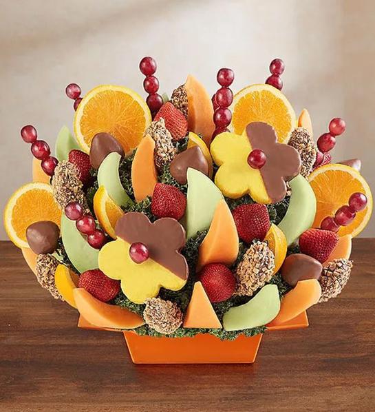 A photo of birthday gifts for sister with a large fruit bouquet with chocolate covered fruit