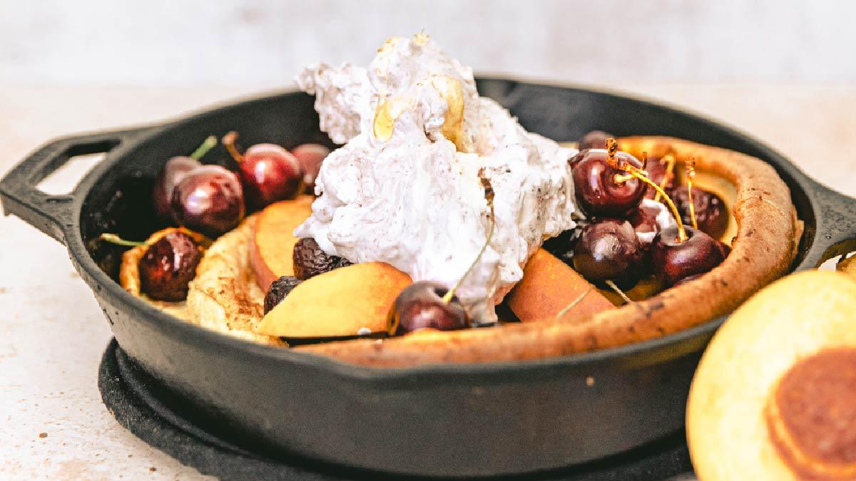 Peach and Roasted Cherry Dutch Baby with Marionberry Whipped Cream