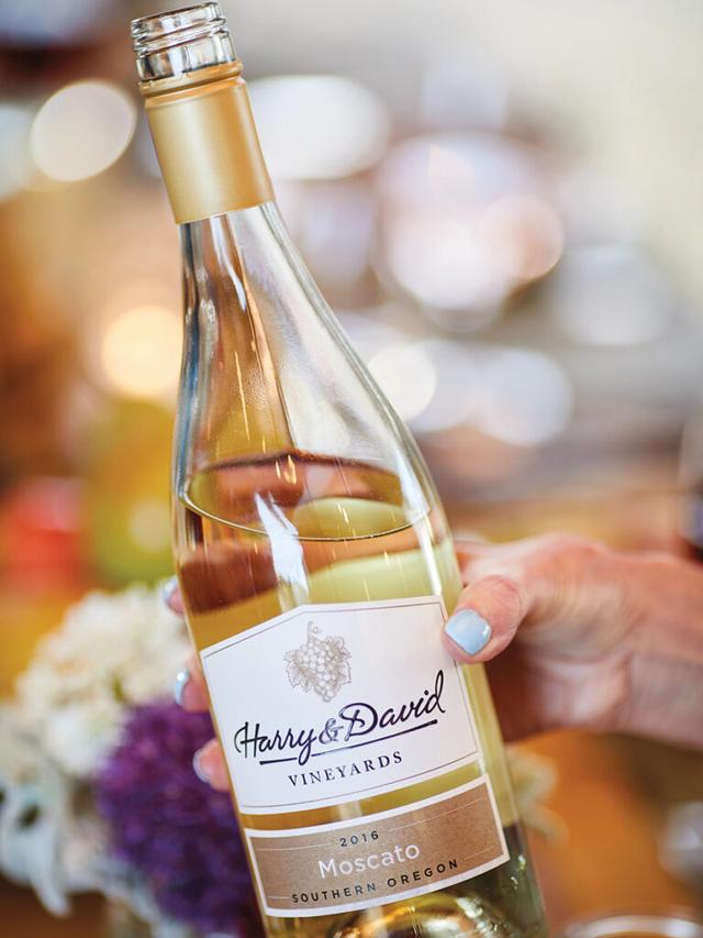 Bottle of Moscato held by a hand.