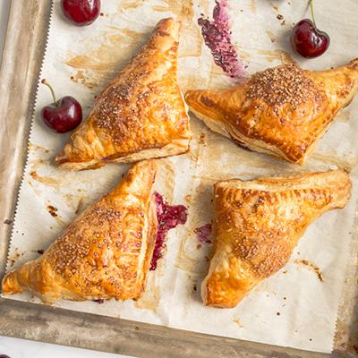 Types of pastries with a platter of cherry turnovers.