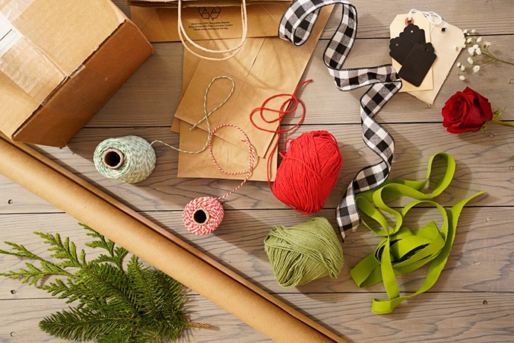 Christmas wrapping paper items and greenery.