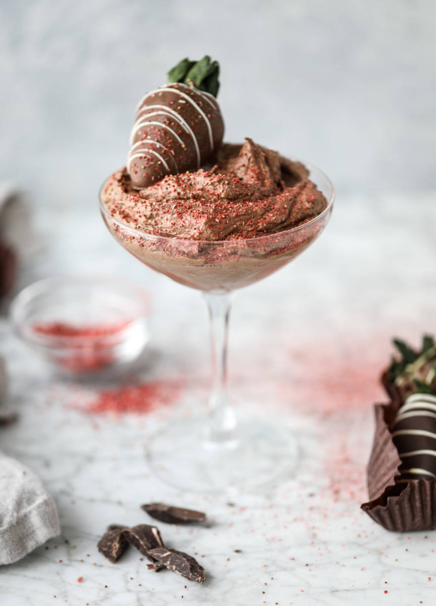 Valentines Day dessert ideas with a cup of chocolate mousse topped with a chocolate covered strawberry