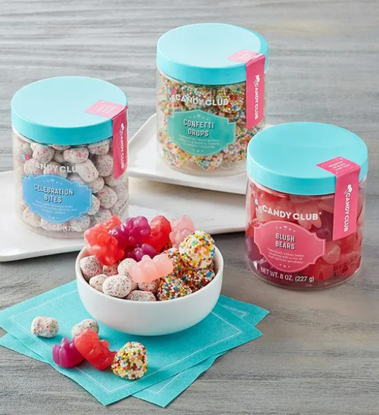 A photo of Easter candy with three jars of candy and a bowl full of candy next to them