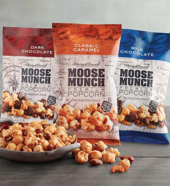 A photo of Easter basket stuffers with three bags of Moose Munch with a bowl full of Moose Munch in front