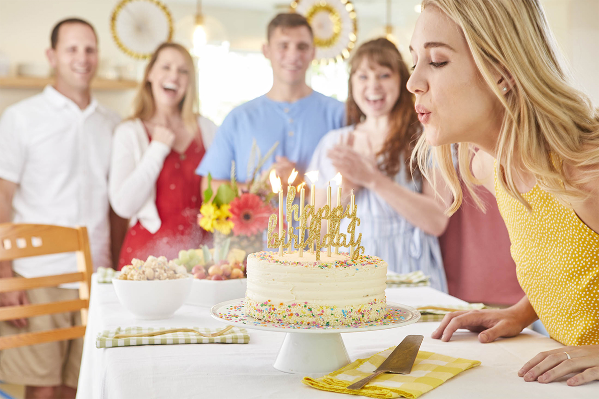 blowing out candles on a birthday cake