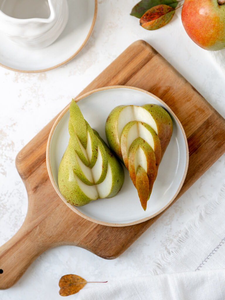 How to cut pears with a platter of pears sliced into a dovetail shape.