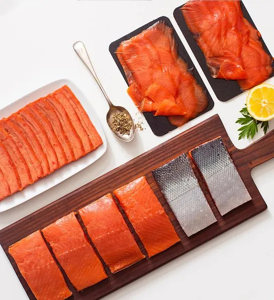 Christmas gifts for him with multiple kinds of slices of raw salmon on a table