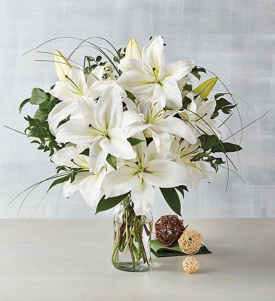 A photo of thanksgiving host gifts with a bouquet of white lilies