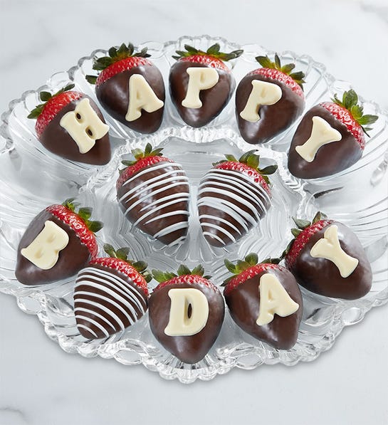 A photo of birthday gift ideas with a plate of chocolate covered strawberries with lettering on them