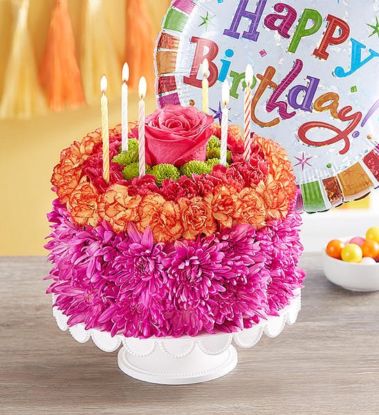 A photo of birthday gift ideas with a cake made out of flowers