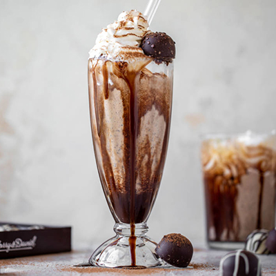 Chocolate truffle milkshake in a tall glass