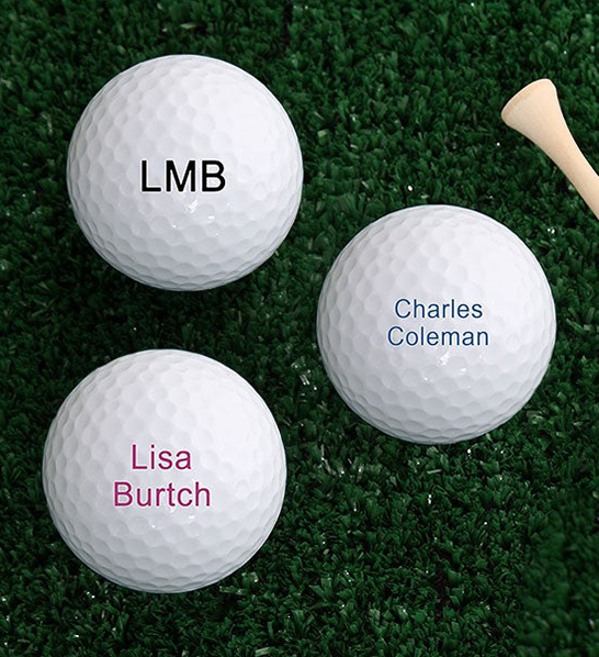 A photo of gifts for couples with three golf balls with personalized names on them