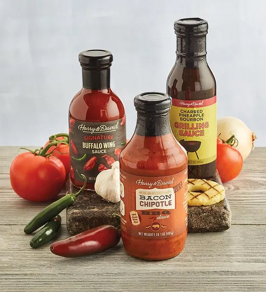 Valentines Day gifts for him with three types of grilling sauces surrounded by ingredients