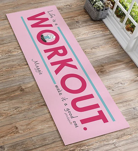 A photo of gifts for women with a personalized pink yoga mat