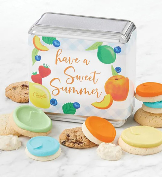 A photo of a picnic tin of cookies that says have a great summer across the lid with cookies surrounding the box