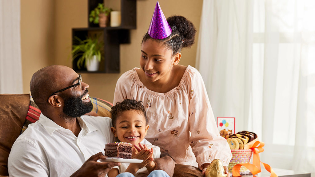 A photo of may birthdays with a family celebrating a birthday with cake