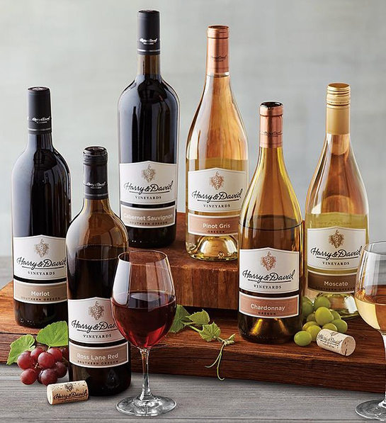 A photo of graduation gift ideas with six bottles of wine on a table