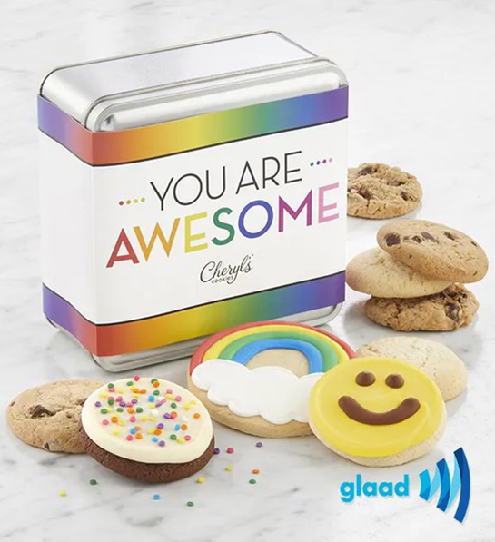 A photo of pride month gifts with a tin with the words you are awesome across it surrounded by cookies