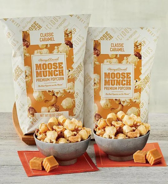 A photo of fathers day gift guide with two bags of moose munch popcorn behind bowls of the same popcorn