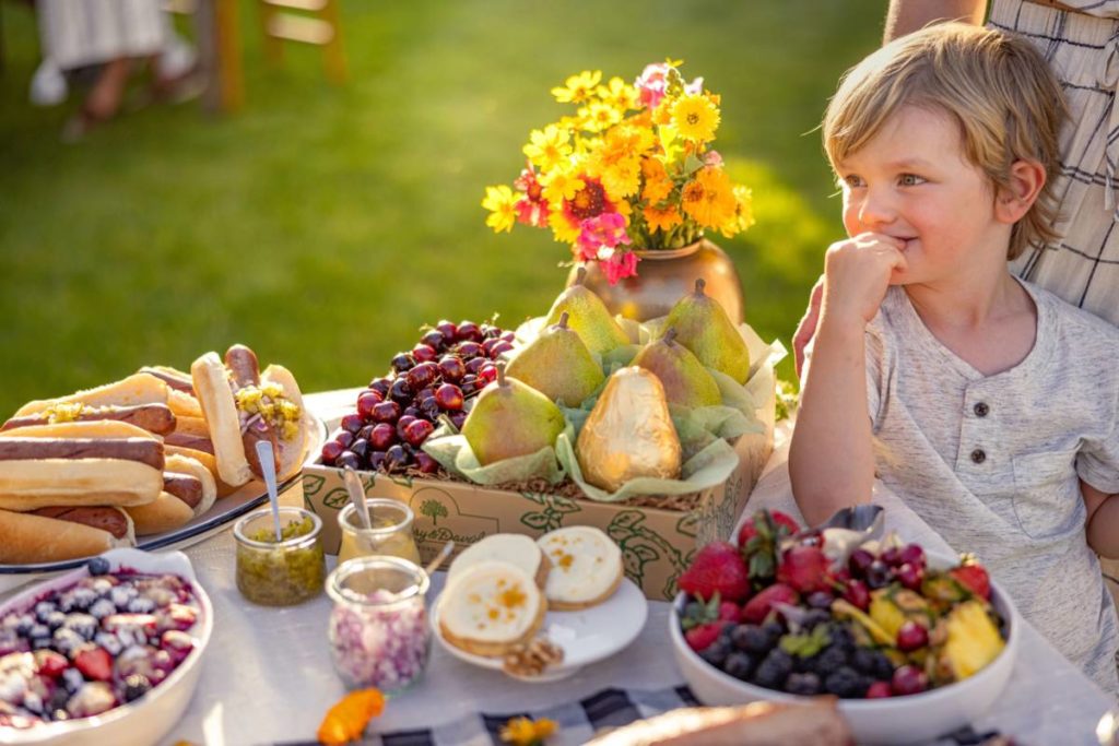 August birthday for a toddler, with a table full of food.