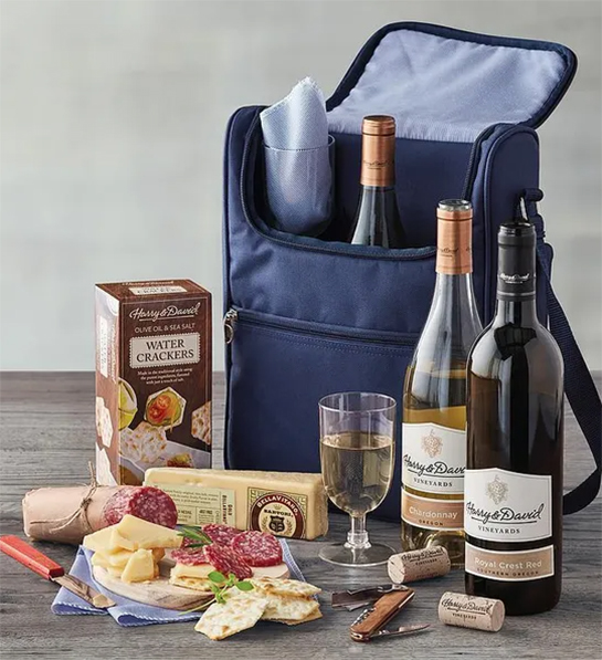 August birthdays with a cooler surrounded by wine cheese meat and other snacks