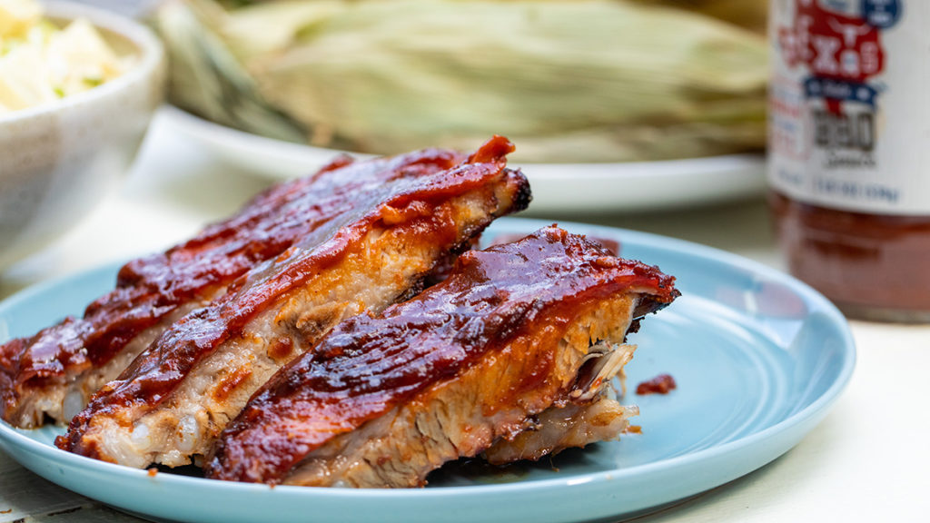 Photo of how to grill with a plate of grilled ribs on a table