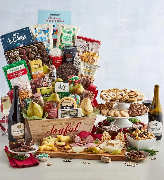 Best gifts with a Christmas gift basket full of sweet and savory snacks next to a bottle of wine