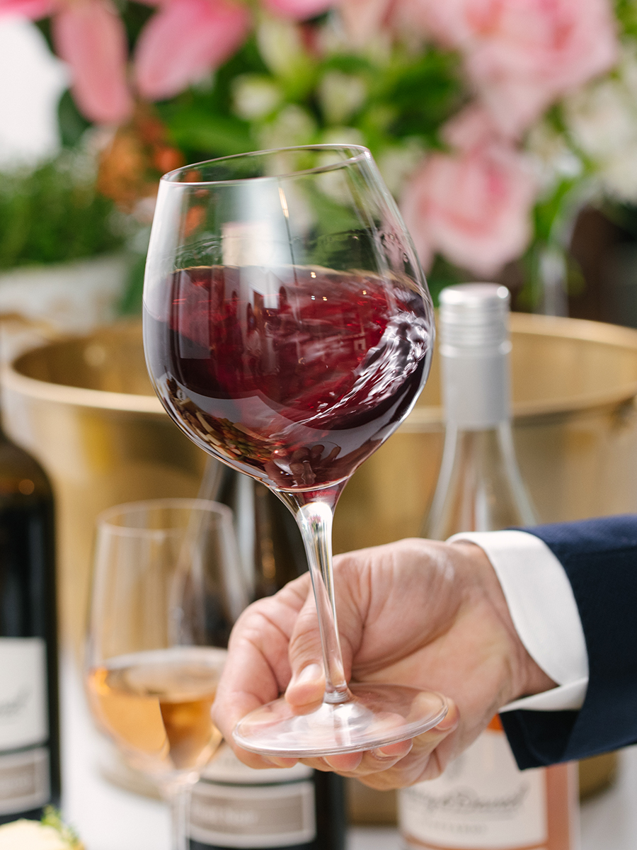 Wine tasting tips with a closeup of a glass of red wine being swirled.