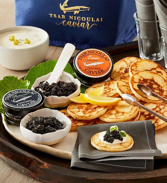 gifting matrix with a tray of caviar and small Russian pancakes