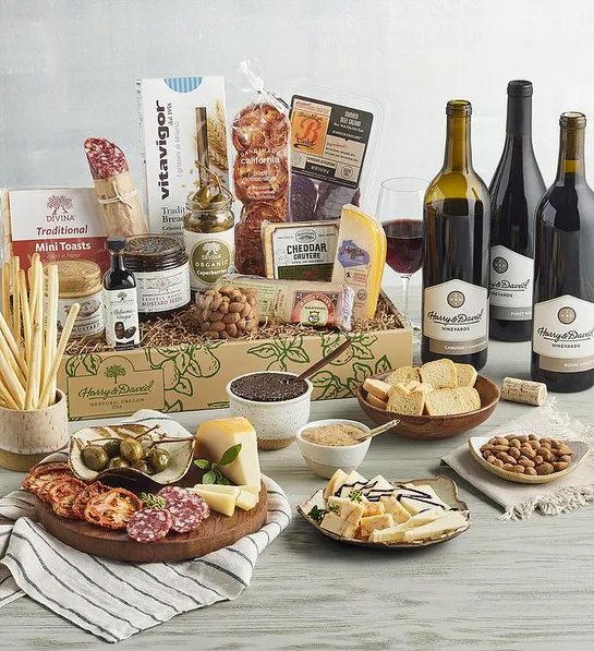 Gifting matrix with a collection of meat cheese and antipasto with three bottles of wine