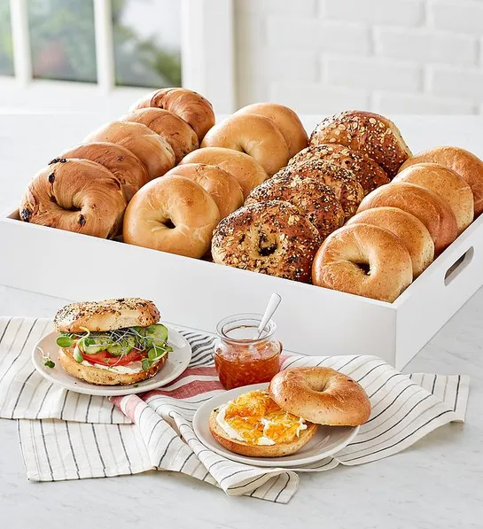 Gifts for coworkers with a box full of bagels with a plate of bagels in front of it