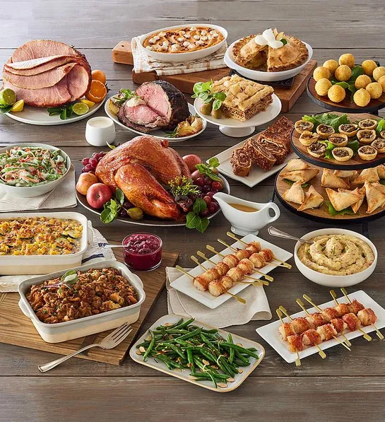 Gifts for coworkers with a table full of gourmet cooked entrees and sides