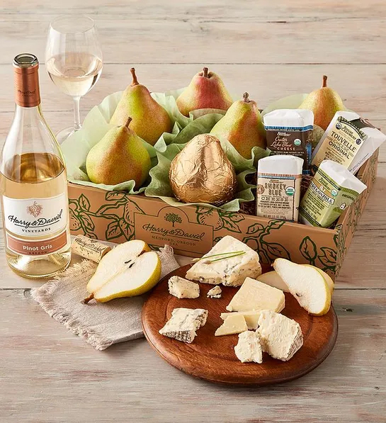 Galentines Day gift ideas with a box of pears and cheese next to a bottle of wine