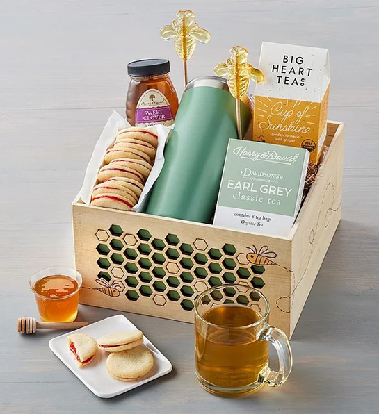 Undercover Snacks with a box full of tea honey cookies and other tea essentials