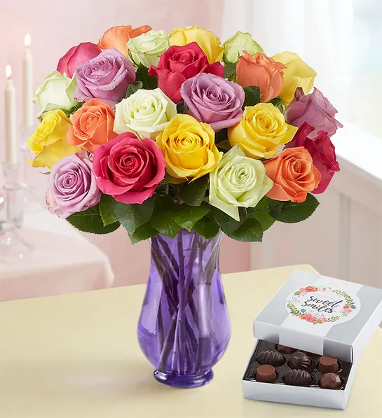 Unique thank you gifts with a bouquet of multi colored roses next to a box of chocolates