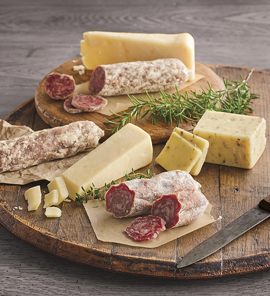 Mother in law gifts with a wooden cutting board full of cheese and charcuterie