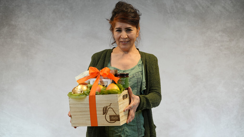 Packing baskets with a woman holding a Harry & David basket.